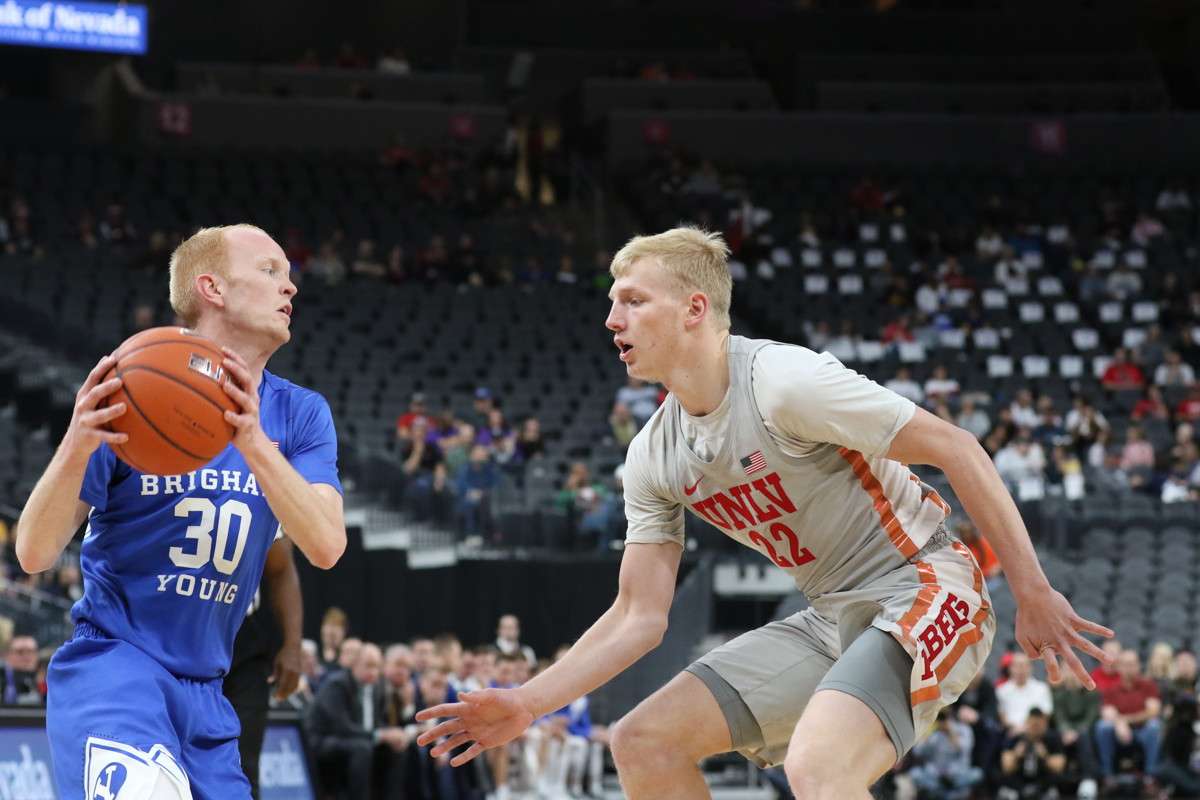 UNLV guard Trey Woodbury (right) defends BYU's TJ Haws in a win over BYU last season at T-Mobile Arena in Las Vegas. The former four-star recruit is transferring to Utah Valley and will be eligible to play immediately for the Wolverines. (Photo: Zak Krill, UNLV Athletics)