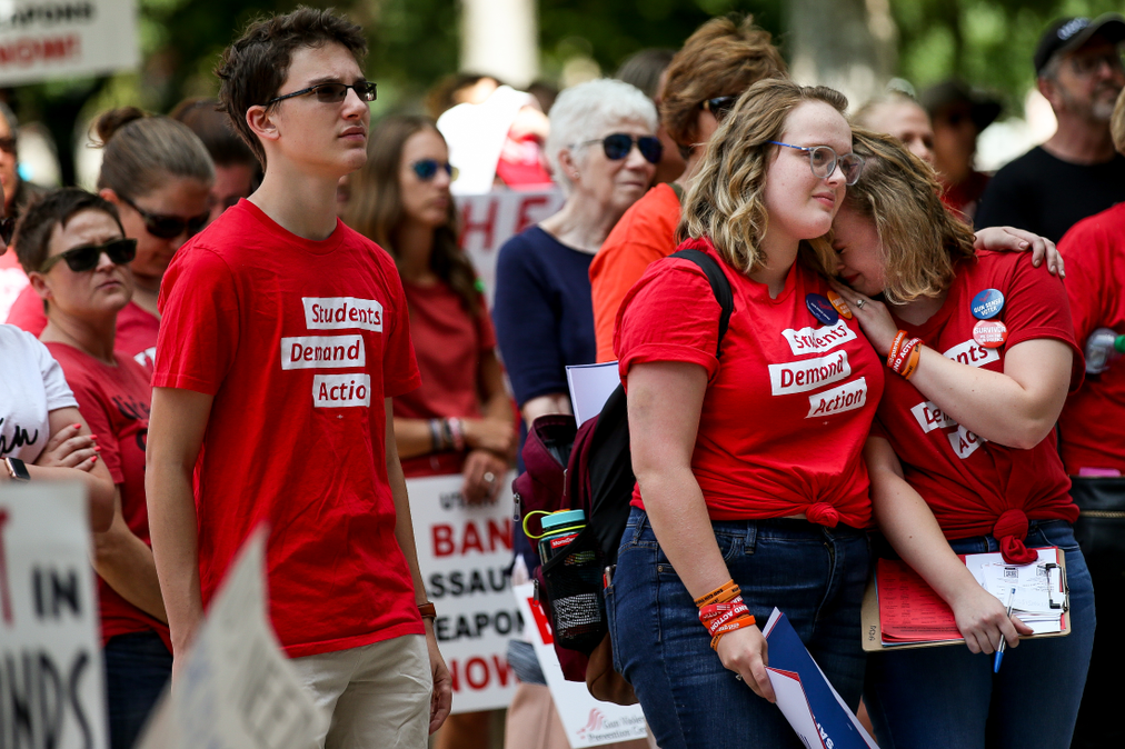 Molly Perez and Bailey Golding, both 19-year-old students at Brigham Young University and leaders of Students Demand Action for Salt Lake and Utah Counties, embrace during a rally for stronger gun control laws at the Salt Lake City-County in Salt Lake City on Saturday, Aug. 17, 2019. (Spenser Heaps, KSL)
