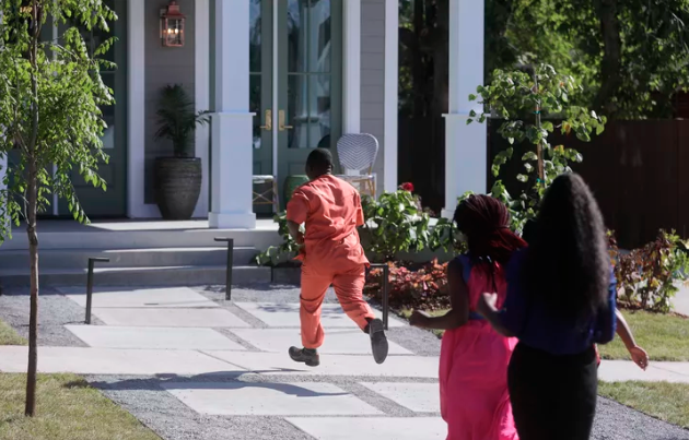 Ashraf Kambere runs to his new house in Ogden on Thursday, Aug. 15, 2019. The six-bedroom house was the gift of HGTV’s “Extreme Makeover: Home Edition,” Ogden general contractor Wadman Corp. and an army of volunteers who build the house within a week. (Photo: Kristin Murphy, KSL)