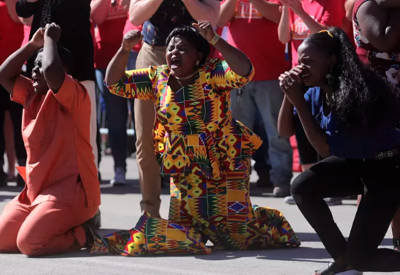 Ashraf Kambere, Anifah Barobi and Azida Kahindo react to seeing their new house in Odgen as a bus from HGTVs “Extreme Makeover: Home Edition” moves to reveal it in Ogden on Thursday, Aug. 15, 2019. Barobi, her daughter, Kambere and his siblings were reunited at a refugee camp in Uganda after fleeing the Democratic Republic of Congo where Kambere’s parents were murdered. After years in the refugee camp they all came to Utah together. (Photo: Kristin Murphy, KSL)
