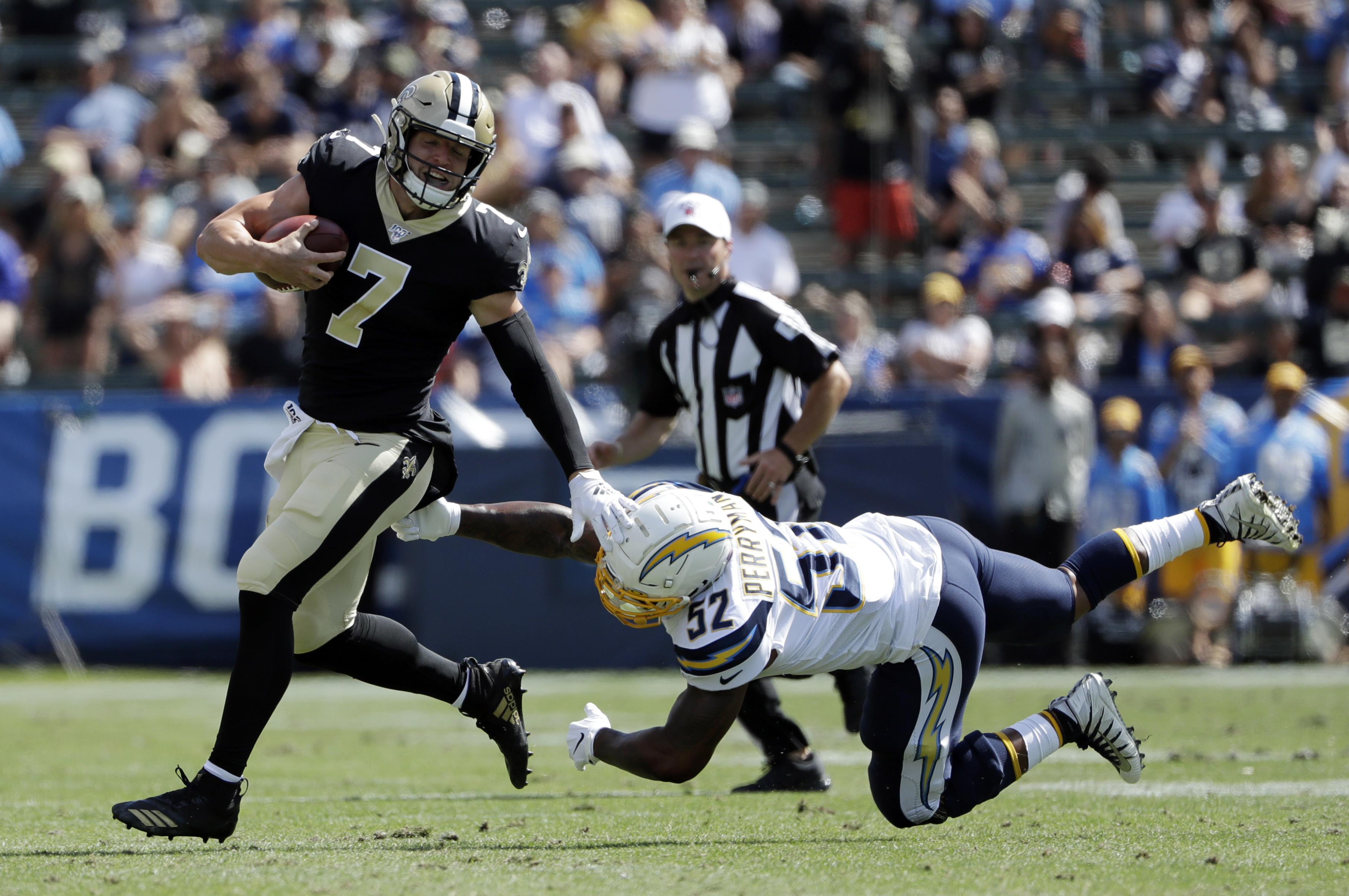 New Orleans Saints quarterback Taysom Hill (7) runs against the Los Angeles Chargers' Denzel Perryman (52) during the second half of a preseason NFL football game Sunday, Aug. 18, 2019, in Carson, Calif. (Photo: Gregory Bull, AP)