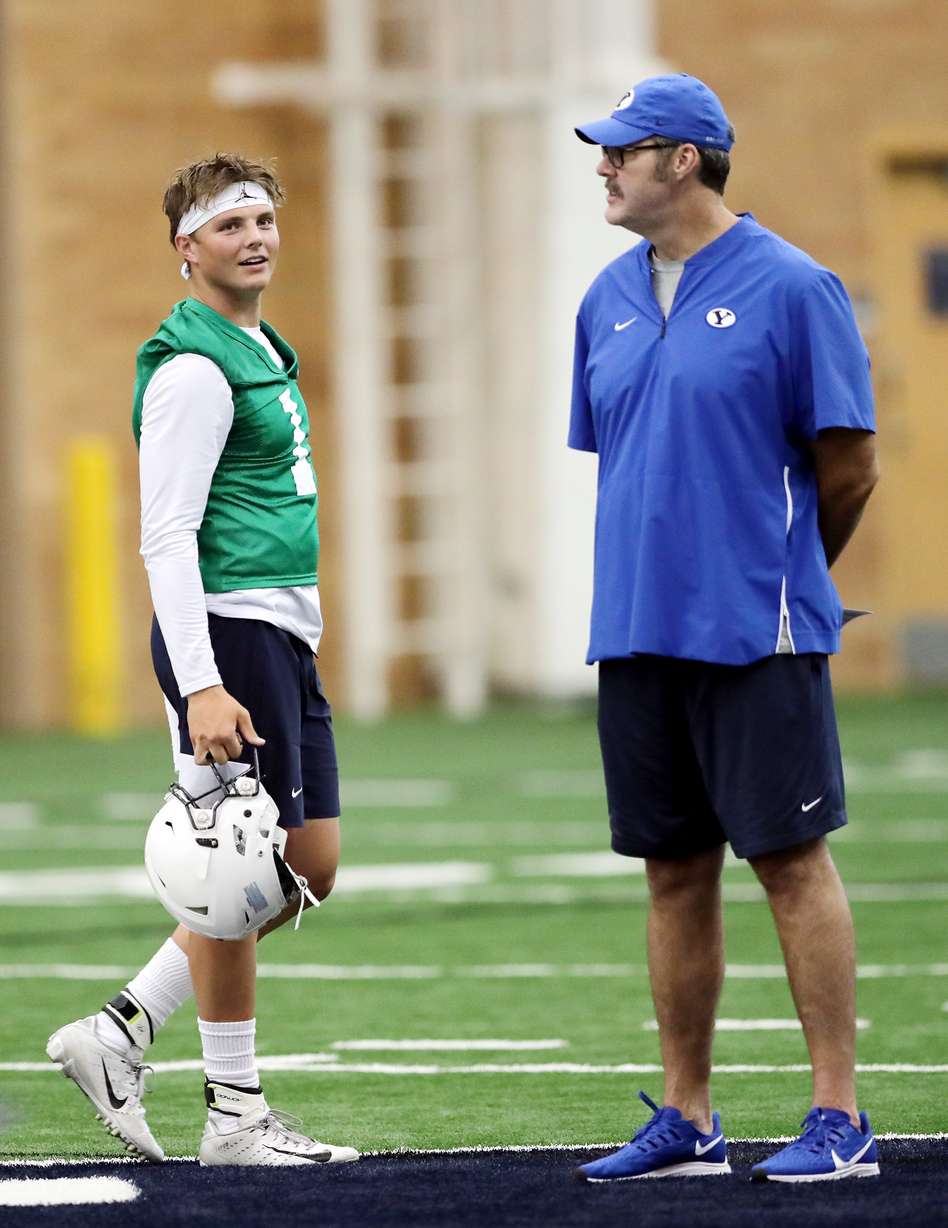 Quarterback Zach Wilson walks near Offensive Coordinator Jeff Grimes as BYU opens football practice at the indoor facility in Provo on Wednesday, July 31, 2019. (Photo: Scott G Winterton, KSL.)