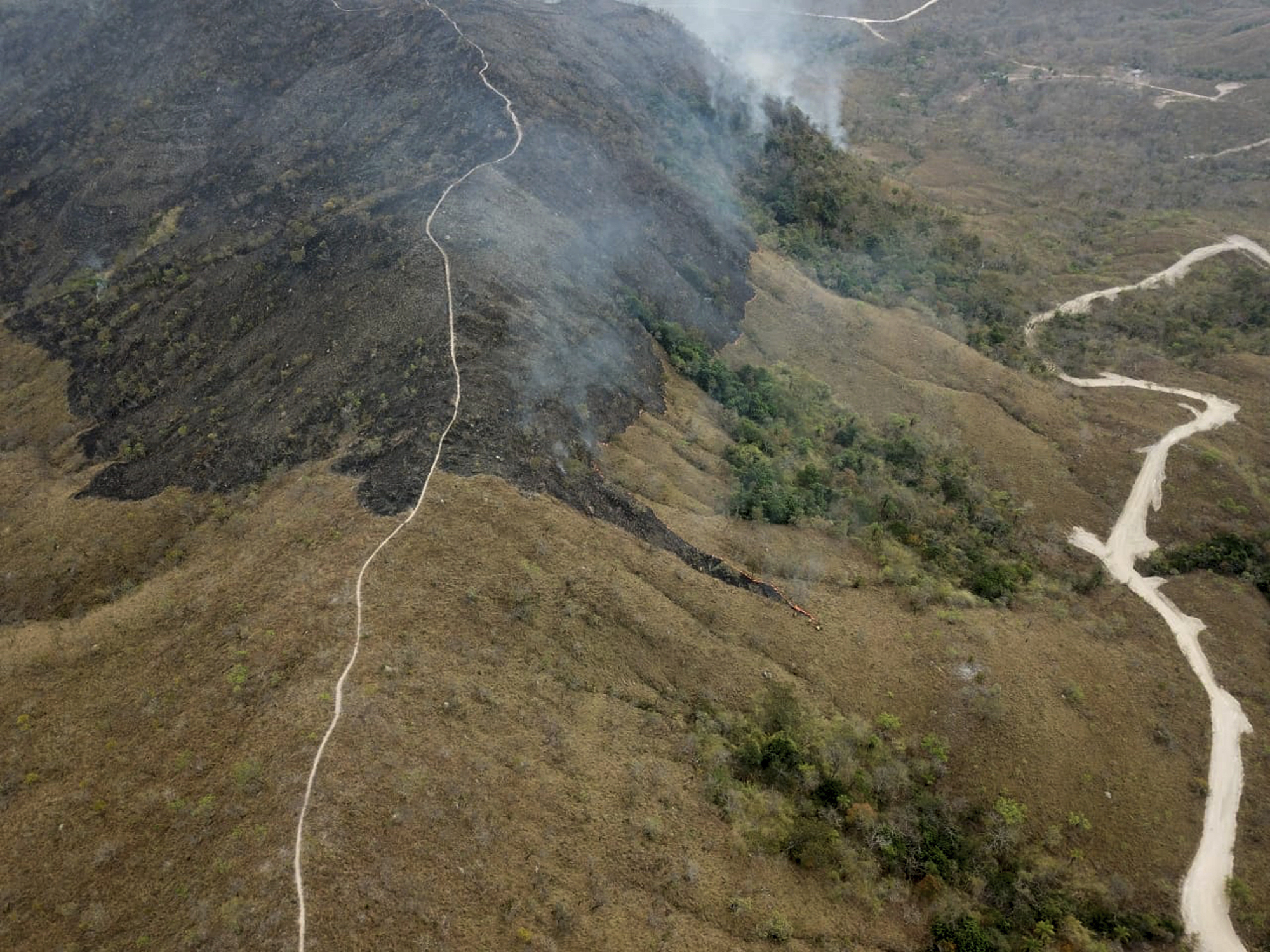 This photo released by Mato Grosso Firefighters, shows the Chapada dos Guimaraes wild fires, in Mato Grosso state, Brazil, Friday, Aug. 23, 2019. Brazilian President Jair Bolsonaro on Friday said he might send the military to fight massive fires in the Amazon as an international outcry over his handling of the environmental crisis grows. (Matto Grosso Fire Department via AP)
