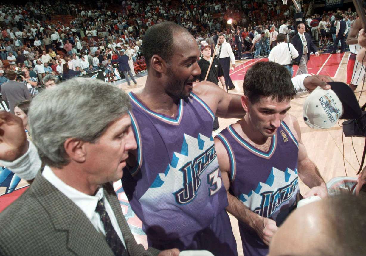 Utah Jazz's John Stockton, right, walks off the court with teammate Karl Malone, center, and coach Jerry Sloan after beating the Houston Rockets 103-100 in Game 6 of the Western Conference Finals Thursday, May 29, 1997, in Houston. Stockton hit a three-point shot at the buzzer to win the game and advance his team to The NBA Finals to meet the Chicago Bulls. (Pat Sullivan, AP Photo)