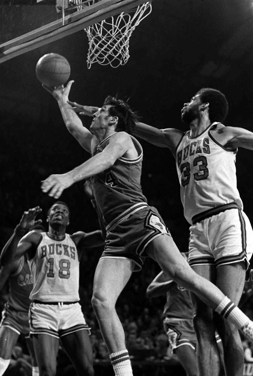 Chicago Bulls Jerry Sloan (4) glides between the baseline and Milwaukee Bucks Kareem Abdul-Jabbar (33) for two points, Feb. 16, 1974, in Milwaukee. (AP Photo)