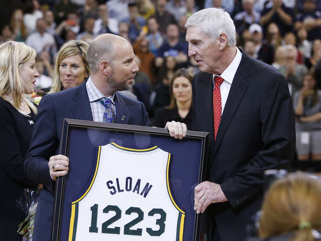 Steve Miller hands former Utah Jazz coach Jerry Sloan a jersey as his banner unveiled in his honor during halftime of the Utah Jazz game in Salt Lake City Friday, Jan. 31, 2014. (Photo: Jeffrey Allred, KSL)