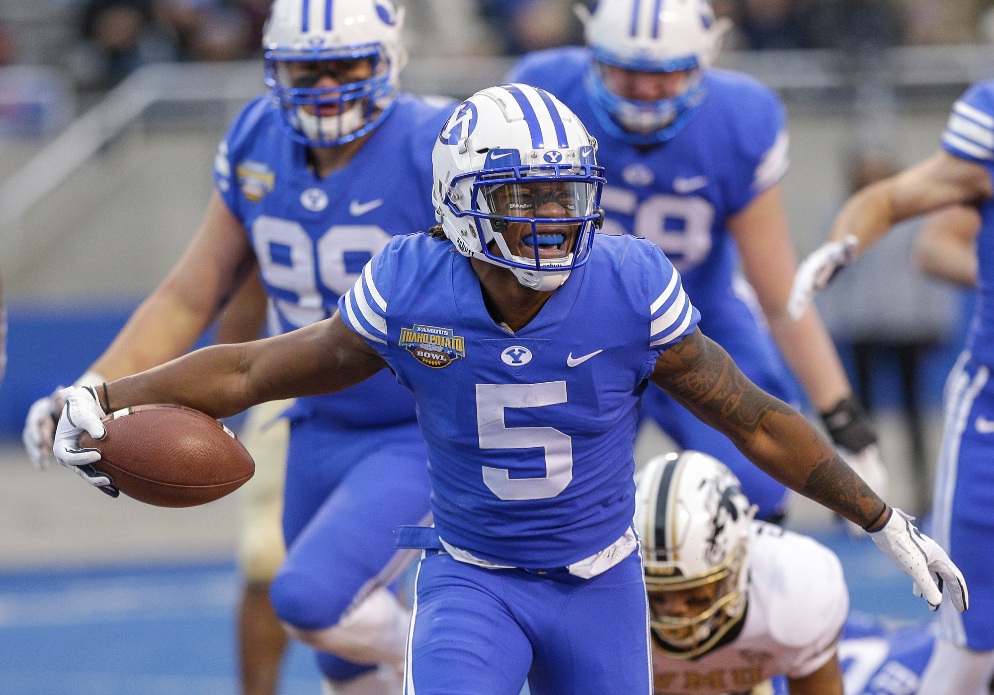 BYU defensive back Dayan Ghanwoloku (5) celebrates a 1-yard touchdown run against Western Michigan in the second half of the Famous Idaho Potato Bowl NCAA college football game, Friday, Dec. 21, 2018, in Boise, Idaho. (AP Photo/Steve Conner)