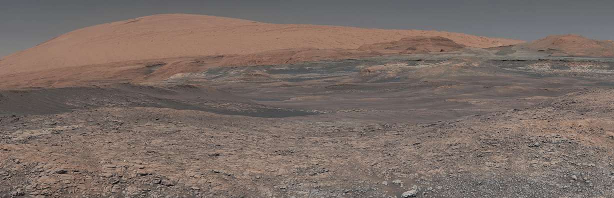 This image provided by NASA, assembled from a series of January 2018 photos made by the Mars Curiosity rover, shows an uphill view of Mount Sharp, which Curiosity had been climbing. In our solar system family, Mars is Earth’s next-of-kin, the next-door relative that has captivated humans for millennia. The attraction is sure to grow on Monday, Nov. 26 with the arrival of a NASA lander named InSight. (NASA, JPL-Caltech, MSSS via AP)