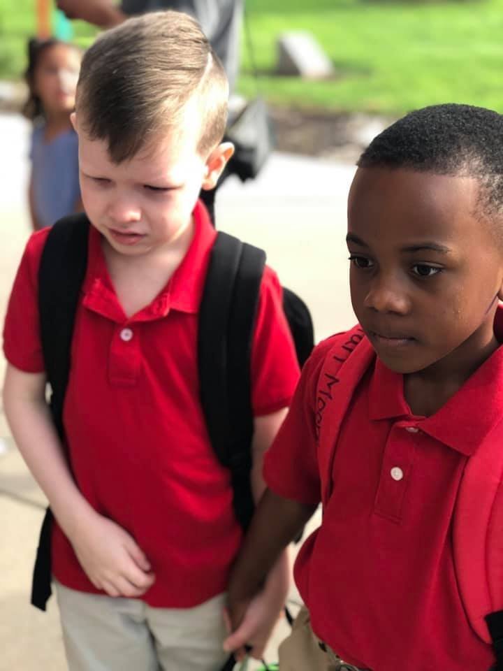 When a boy with autism was overwhelmed on the first day of school, another little boy held his hand
