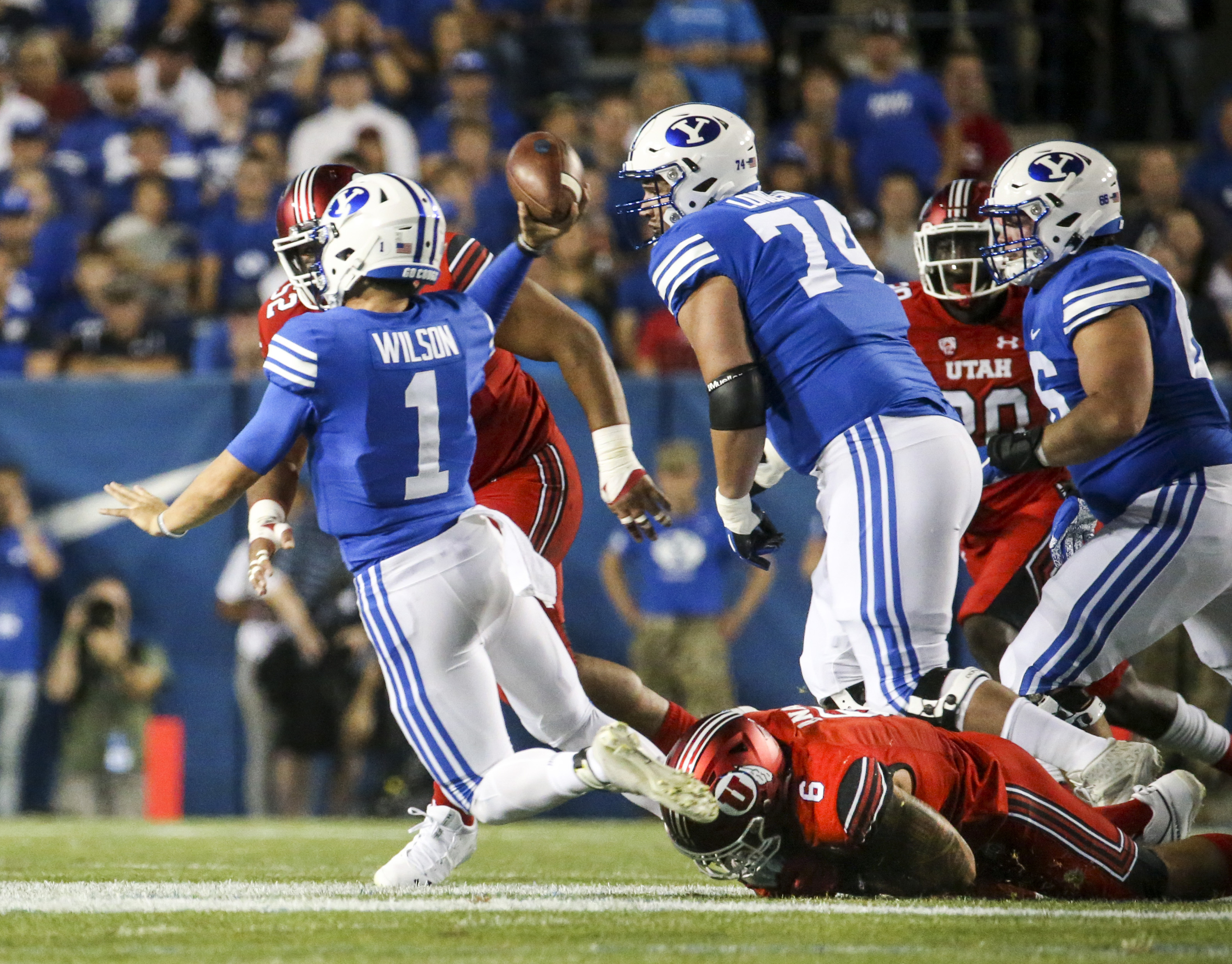 Brigham Young Cougars quarterback Zach Wilson (1) throws an interception under pressure from Utah Utes defensive end Bradlee Anae (6) during the first half of an NCAA football game at LaVell Edwards Stadium in Provo on Thursday, Aug. 29, 2019. (Photo: Colton Peterson, KSL)