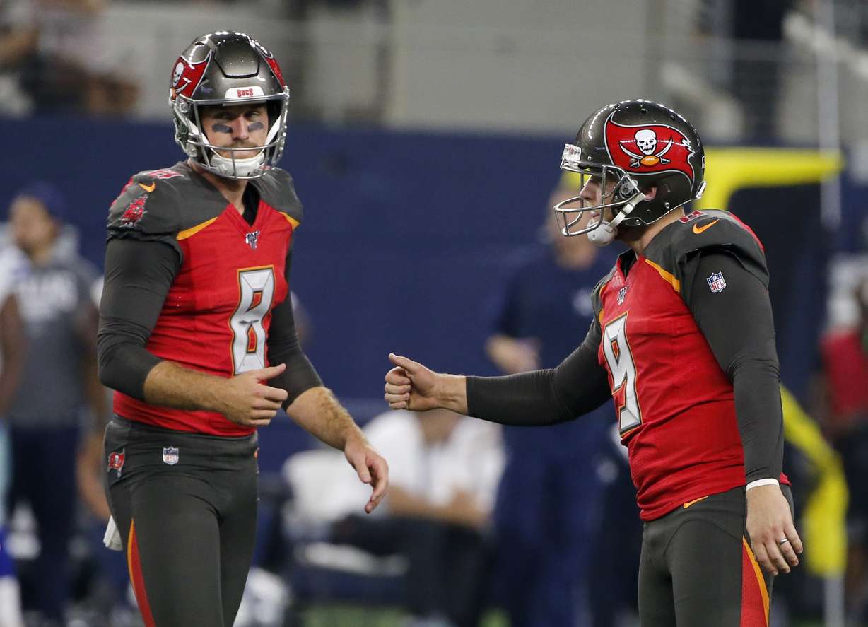Tampa Bay Buccaneers' Bradley Pinion (8) and Matt Gay (9) celebrate a field goal kicked by Gay in the second half of a preseason NFL football game against the Dallas Cowboys in Arlington, Texas, Thursday, Aug. 29, 2019. (AP Photo/Michael Ainsworth)