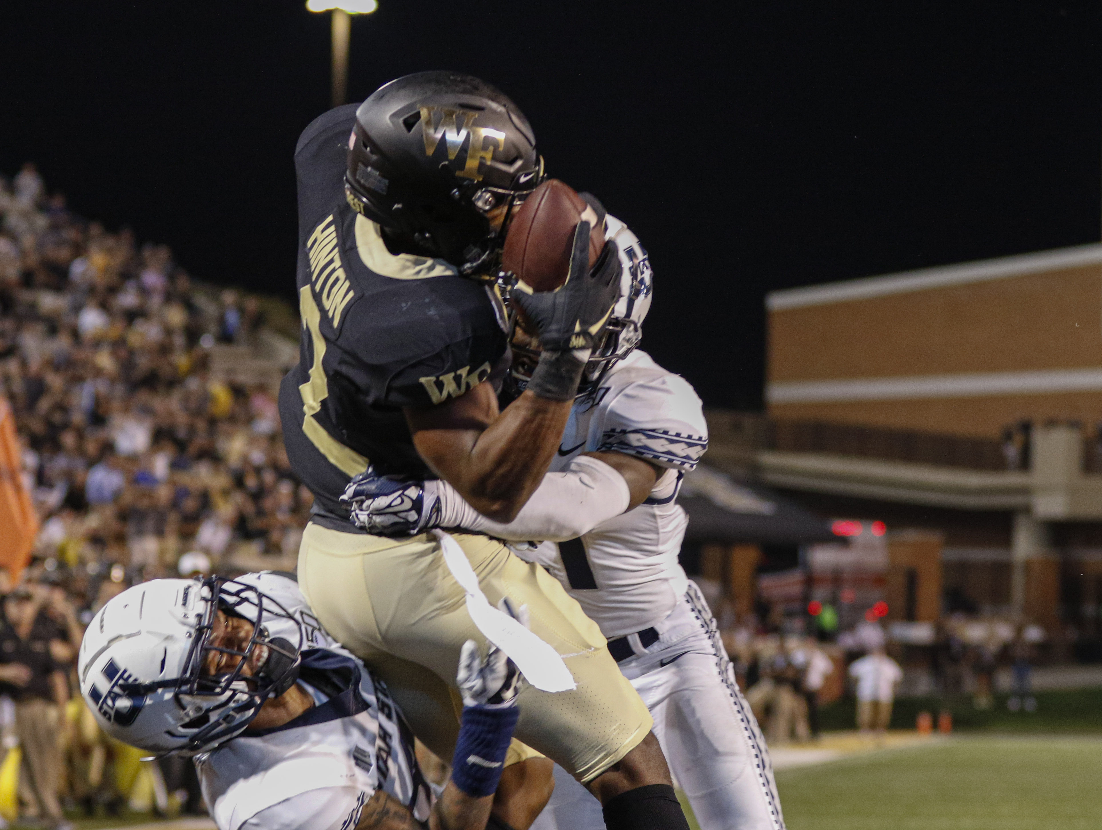 Wake Forest wide receiver Kendall Hinton (2) catches a pass for a touchdown against Utah State late in the fourth quarter of an NCAA college football game in Winston-Salem, N.C., Friday, Aug. 30, 2019. Wake Forest won 38-35. (AP Photo/Nell Redmond)