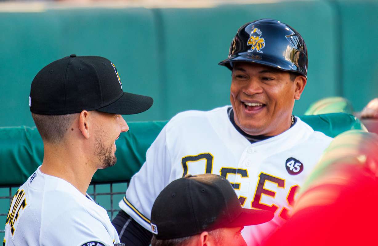 Salt Lake Bees coach Ray Olmedo, right, shares a laugh with Bees pitcher Taylor Cole before a game at Smith's Ballpark on Friday, Aug. 31, 2019. (Photo: Carter Williams, KSL.com)