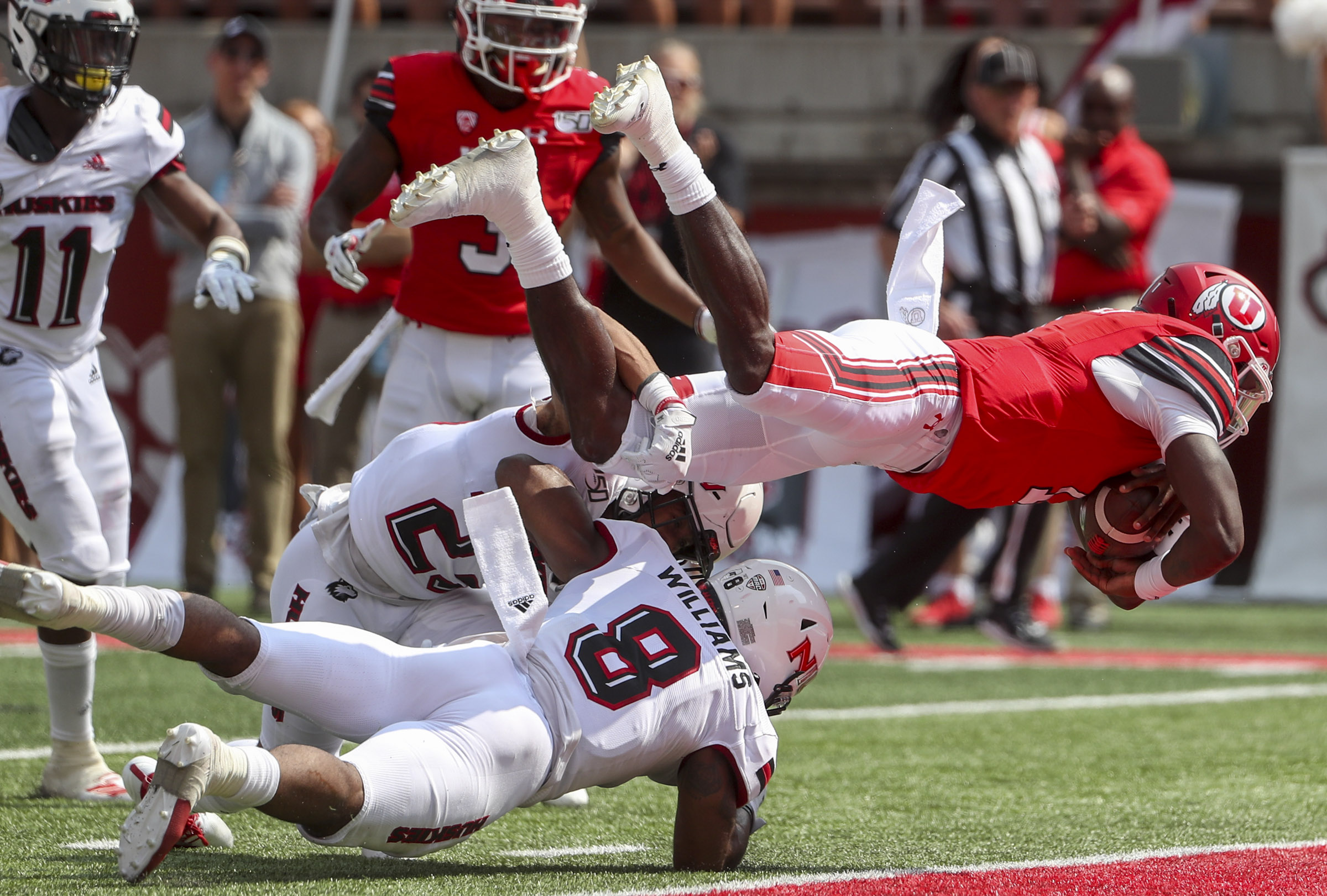 Utah Utes quarterback Tyler Huntley (1) dives over the Northern Illinois Huskies defense and into the end zone for a touchdown during first half action at Rice-Eccles Stadium in Salt Lake City on Saturday, Sept. 7, 2019. (Photo: Steve Griffin, KSL)