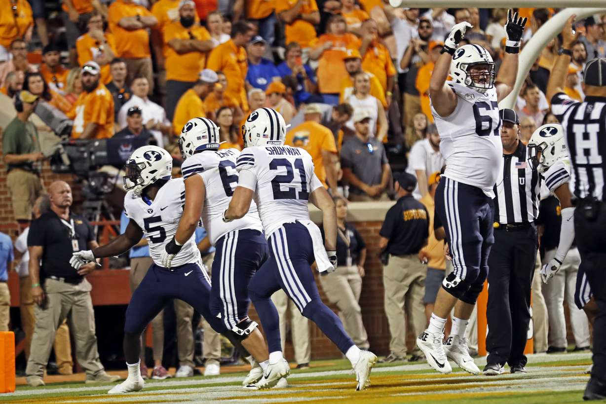 Brigham Young running back Ty'Son Williams (5) celebrates the game-winning touchdown with teammates in overtime an NCAA college football game Saturday, Sept. 7, 2019, in Knoxville, Tenn. Brigham Young won 29-26. (AP Photo/Wade Payne)