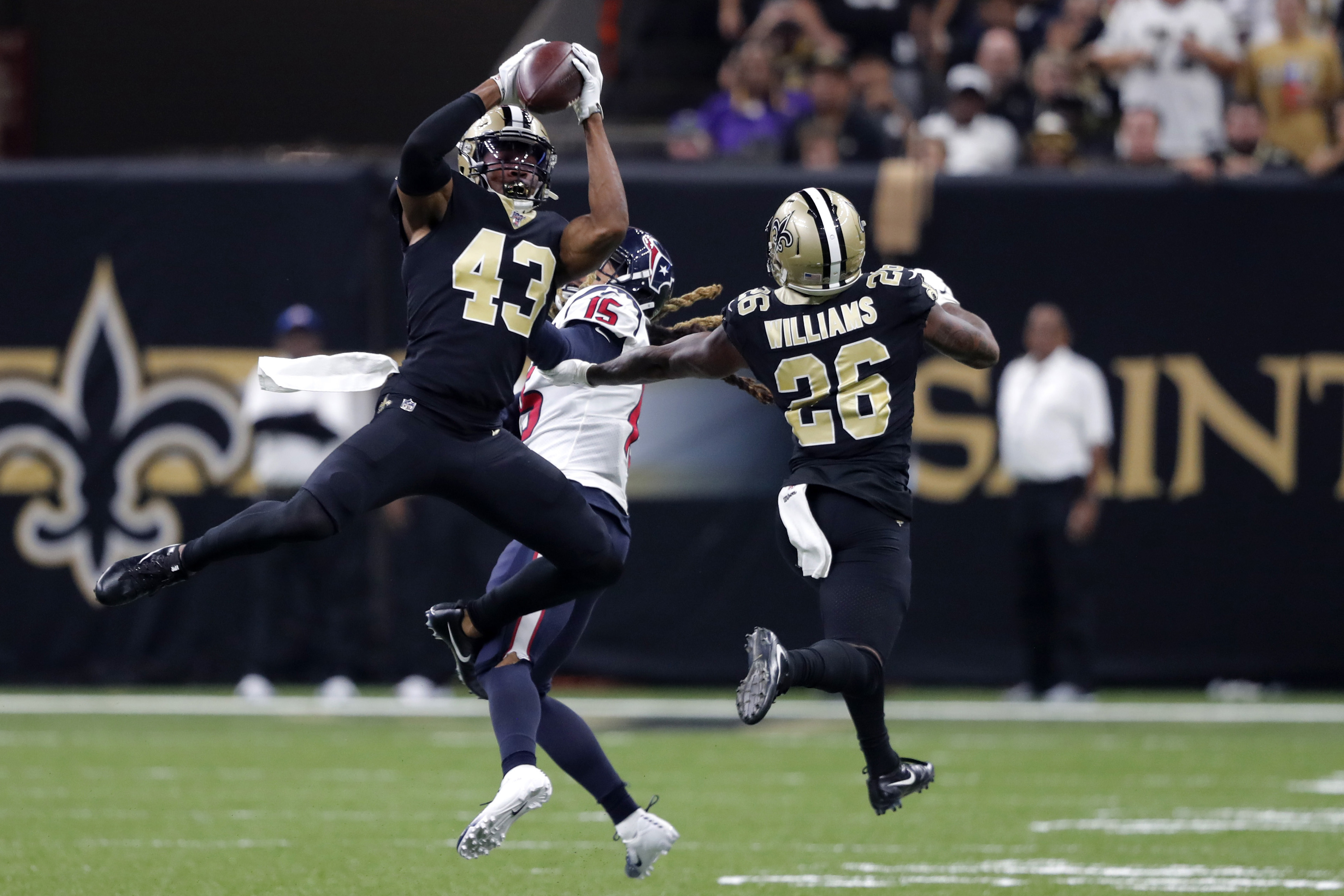 New Orleans Saints free safety Marcus Williams (43) intercepts a pass intended for Houston Texans wide receiver Will Fuller (15) in the second half of an NFL football game in New Orleans, Monday, Sept. 9, 2019. (AP Photo/Bill Feig)