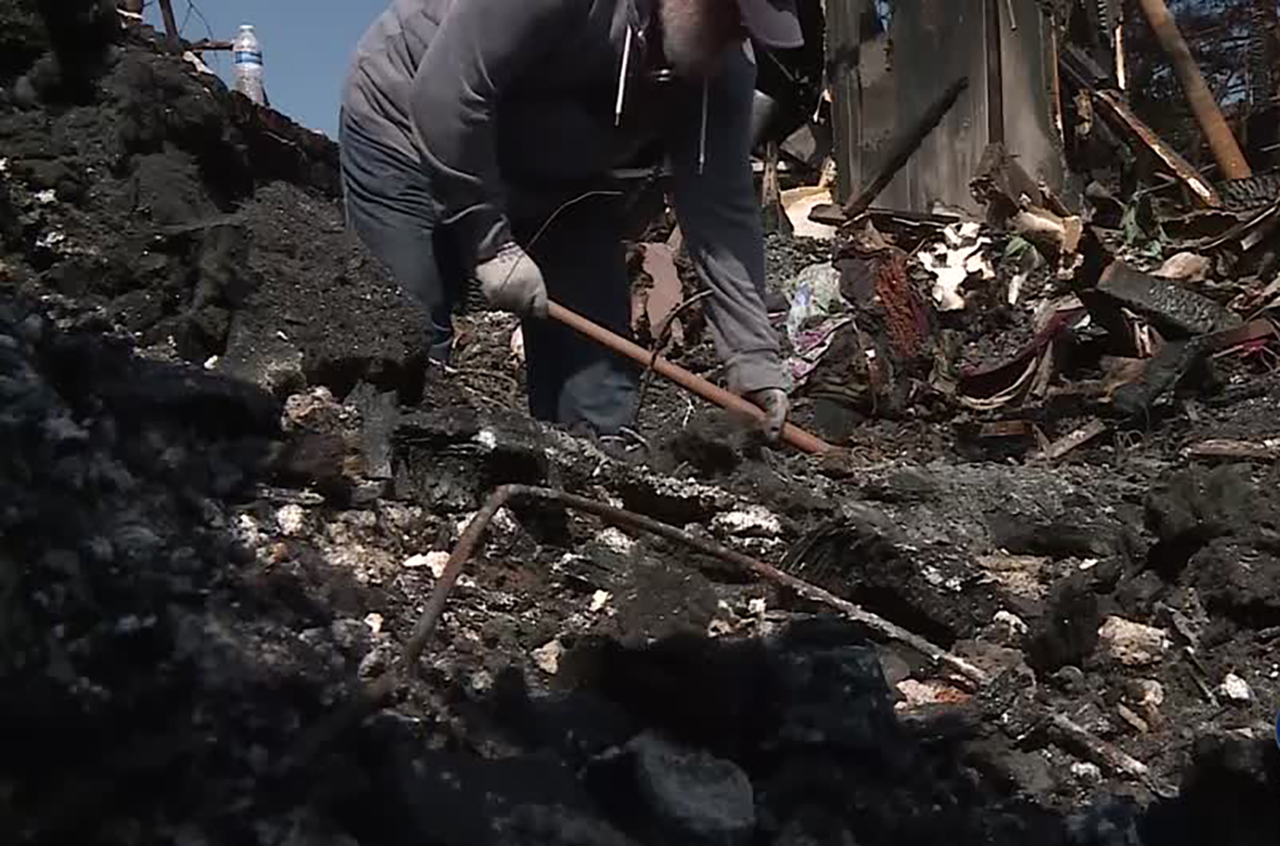 Daniel Fishe digs through the rubble Monday, Sept. 9, 2019. Photo: Meghan Thackrey, KSL TV