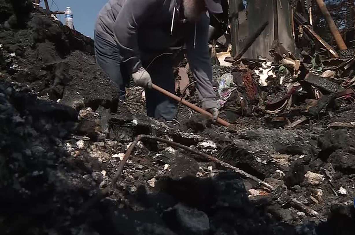 Daniel Fishe digs through the rubble Monday, Sept. 9, 2019. Photo: Meghan Thackrey, KSL TV