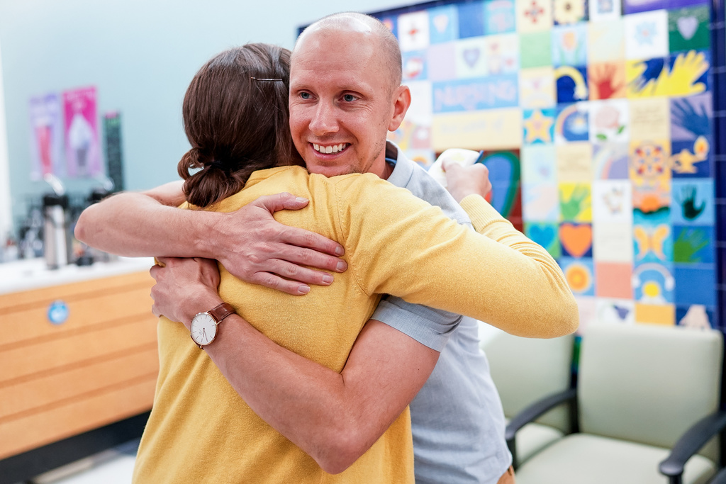Ian Dahl, 32, of Sandy, hugs his friend Sara John, a nurse at Primary Children's Hospital, during a program celebrating 25 years of bone marrow transplants at the hospital in Salt Lake City on Thursday, Sept. 12, 2019. Dahl was one of the first bone marrow transplant patients at the hospital. Photo: Spenser Heaps, KSL