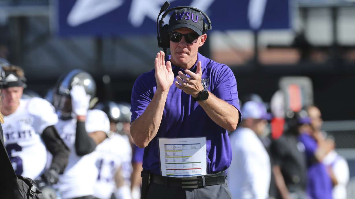 Weber State head coach Jay Hill rallies his team prior to kickoff against Nevada in an NCAA college football game in Reno, Nev., Saturday, Sept. 14, 2019. (AP Photo/Lance Iversen)