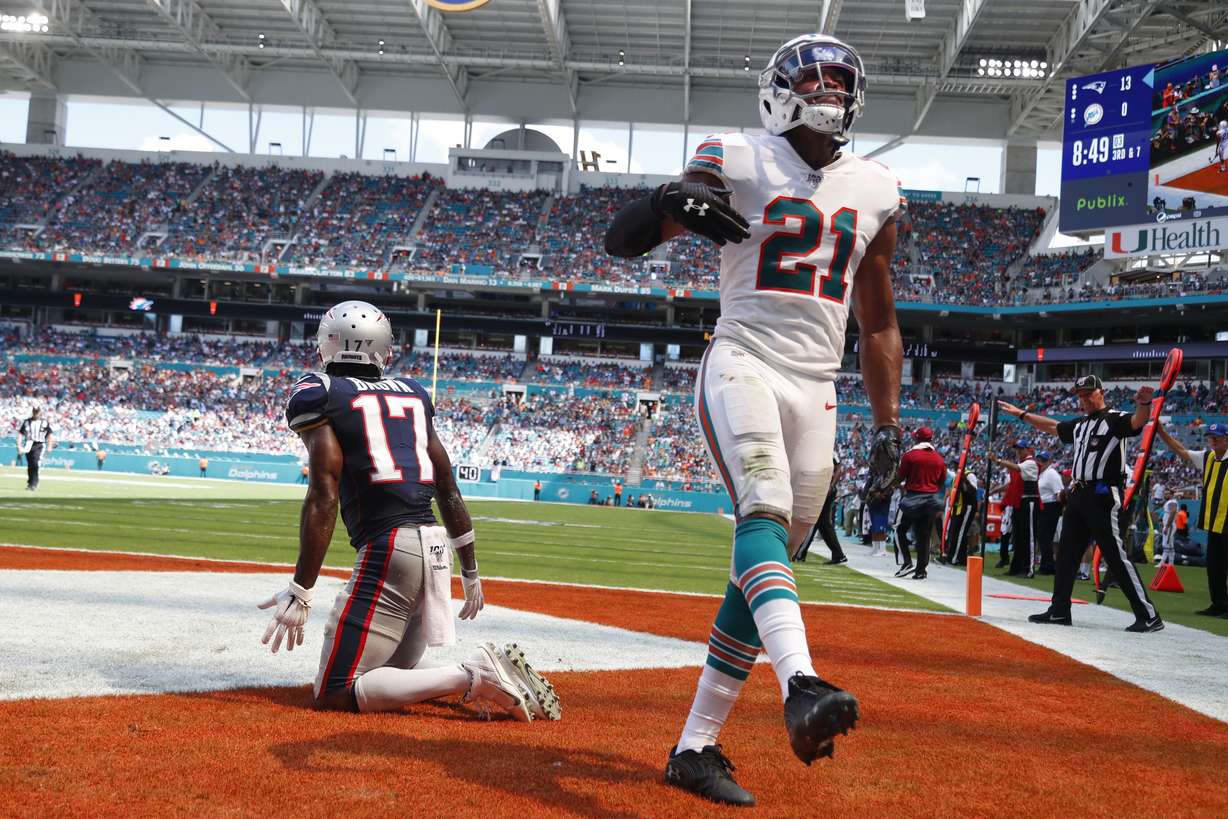 Miami Dolphins cornerback Eric Rowe (21) cheers after defending New England Patriots wide receiver Antonio Brown (17) in he end zone, during the second half at an NFL football game, Sunday, Sept. 15, 2019, in Miami Gardens, Fla. (AP Photo/Wilfredo Lee)