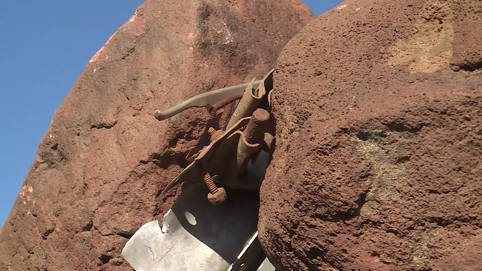 Bolts from a World War II aircraft sit wedged between rocks in Washington County. (Photo: Alex Cabrero, KSL TV)