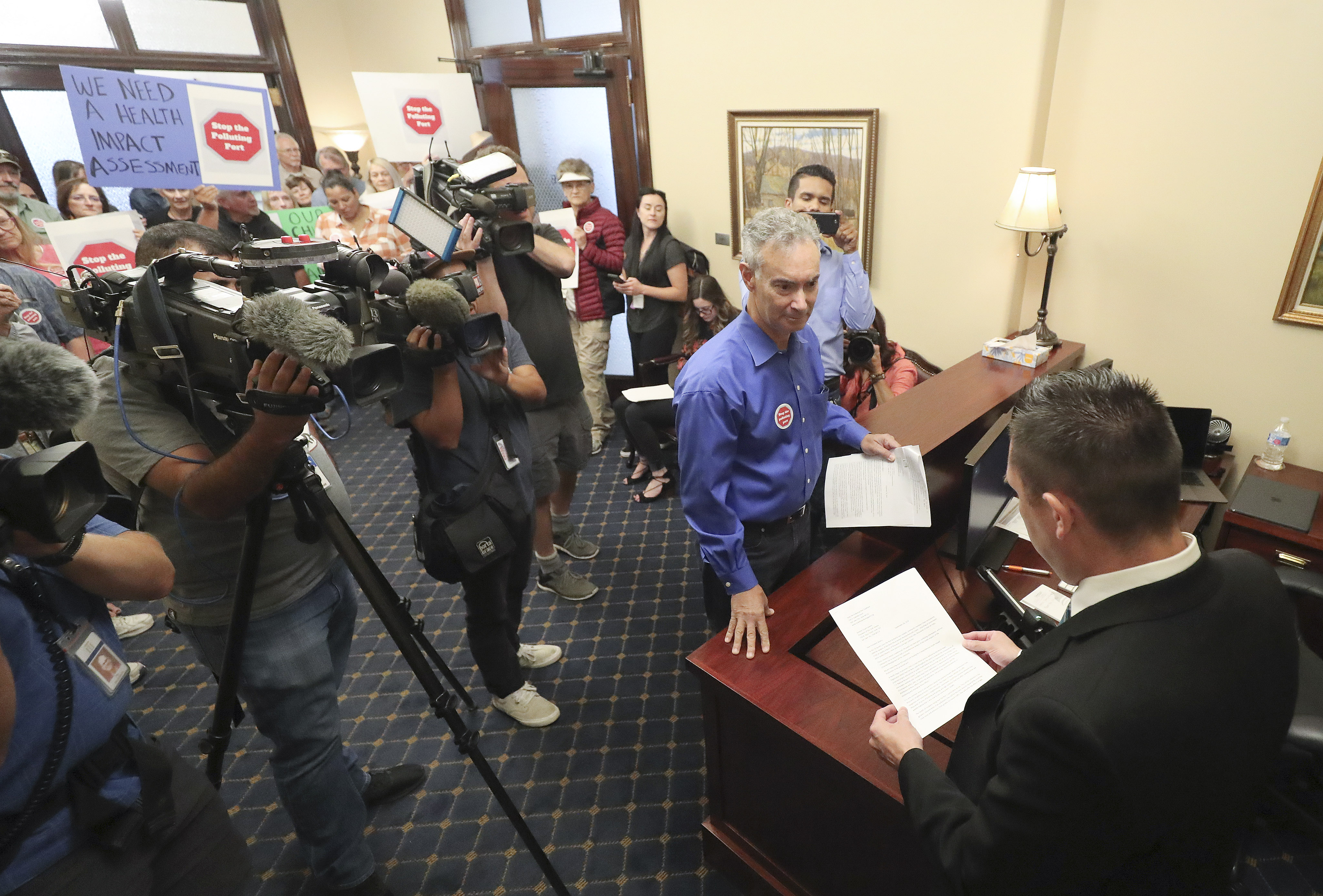 David Scheer and other members of the Stop the Polluting Port Coalition deliver a letter to Senate chief of staff Mark Thomas after holding a rally at the Capitol in Salt Lake City on Wednesday, Sept. 18, 2019. The letter asked for legislative support and funding of a health impact assessment of the proposed Utah Inland Port. (Jeffrey D. Allred, KSL)