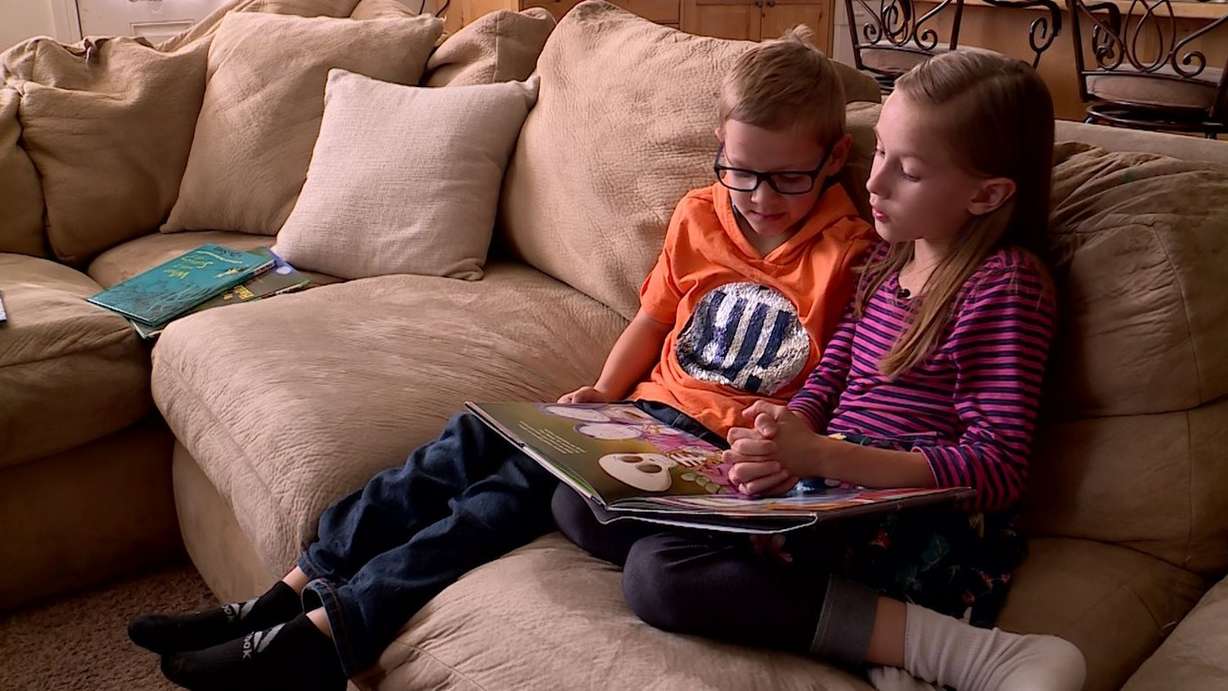 Liam and Kaitlyn Munn read a Halloween children's book together. Photo: KSL TV