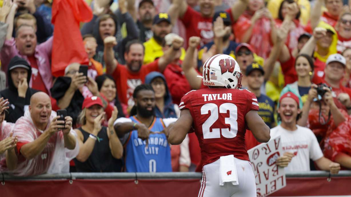 Taylor helps No. 13 Wisconsin trounce No. 11 Michigan 35-14