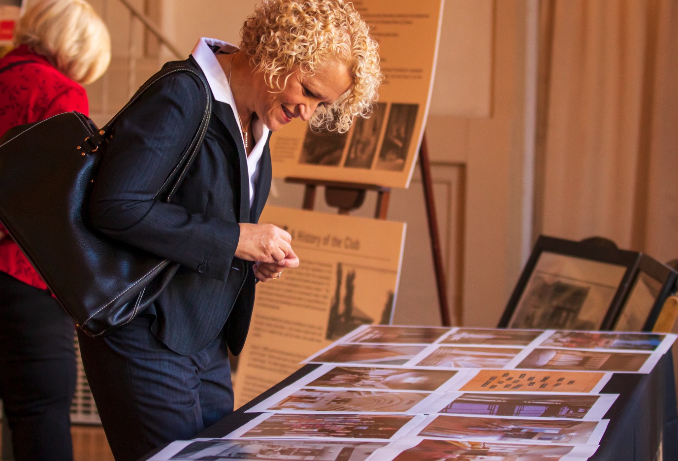 Salt Lake City Mayor Jackie Biskupski looks at old photos throughout the years of The Ladies' Literary Club during an event at Clubhouse in Salt Lake City on Tuesday, Sept. 24, 2019. (Photo: Carter Williams, KSL.com)