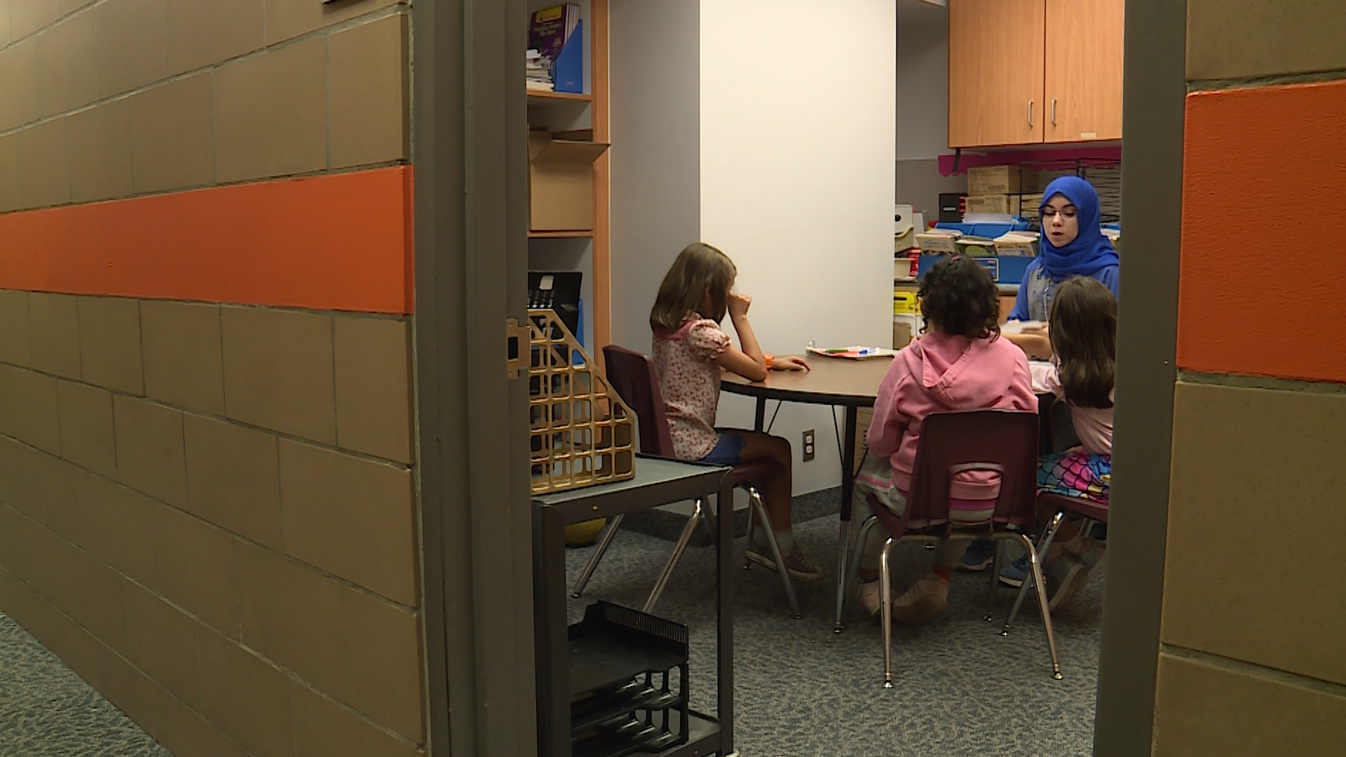 Baraa Arkawazi gives a small group of students some extra help in honing their English skills. (Photo: KSL TV)