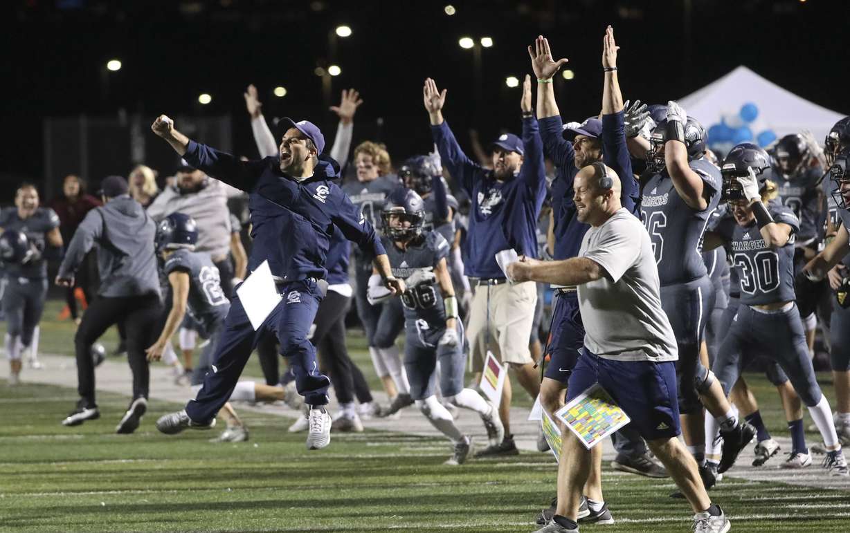 The Corner Canyon bench explodes with excitement after they scored the game-winning touchdown with two seconds left in the game, giving them a victory over Lone Peak at Corner Canyon High School in Draper on Friday, Sept. 27, 2019.