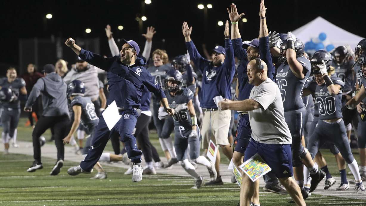 The Corner Canyon bench explodes with excitement after they scored the game-winning touchdown with two seconds left in the game, giving them a victory over Lone Peak at Corner Canyon High School in Draper on Friday, Sept. 27, 2019.