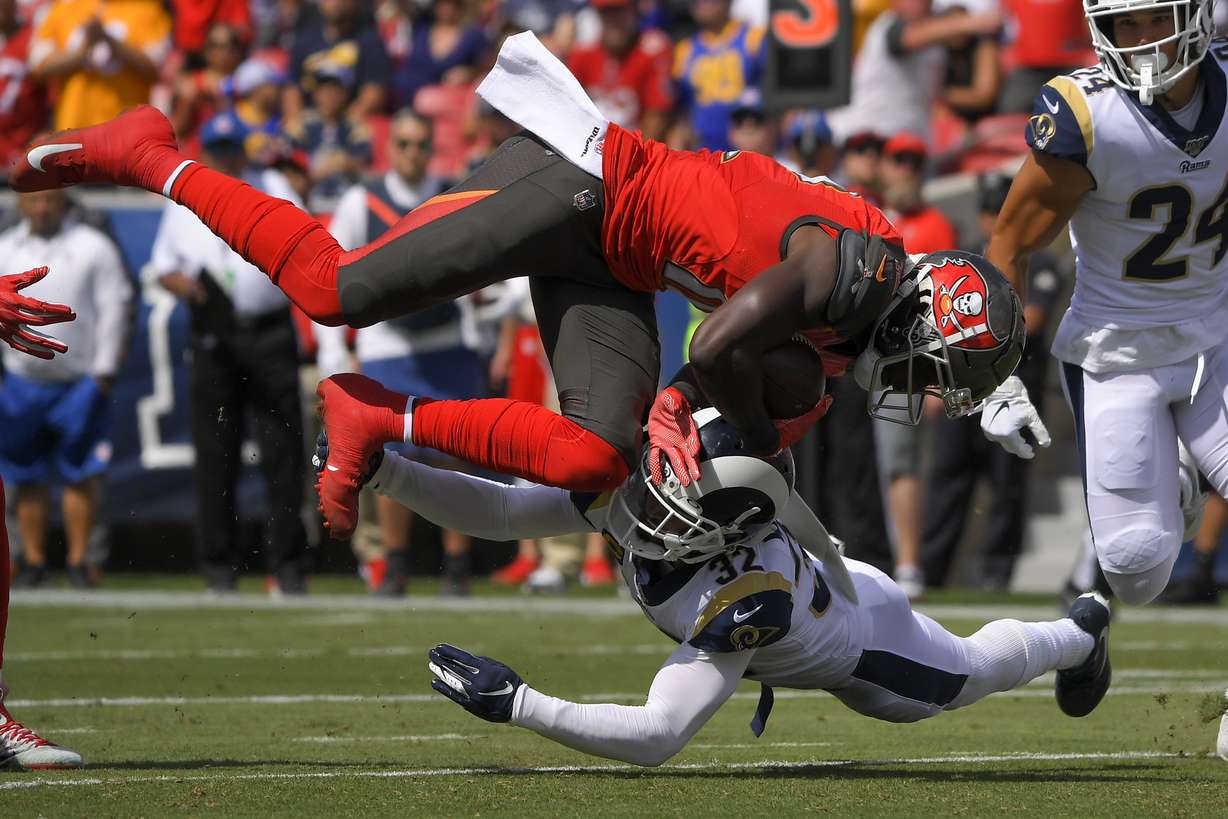 Los Angeles Rams safety Eric Weddle makes a tackle during an NFL game against Tampa Bay, Sept. 29, 2019. After retiring following the 2020 season, Weddle is back on an NFL contract for the Rams' playoff berth that begins Monday night against the Arizona Cardinals.