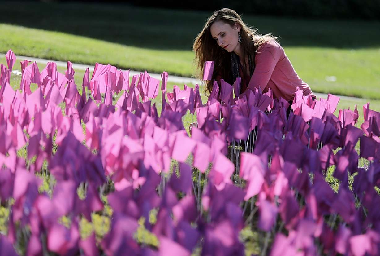 Chrystal Bracken, South Valley Services development assistant, helps place 3,452 flags, each representing an individual who sought safety from domestic violence through Salt Lake County services, on the lawn outside of the Salt Lake County Government Center to kick off Domestic Violence Awareness Month in Salt Lake City on Tuesday, Oct. 1, 2019. (Photo: Kristin Murphy, KSL)