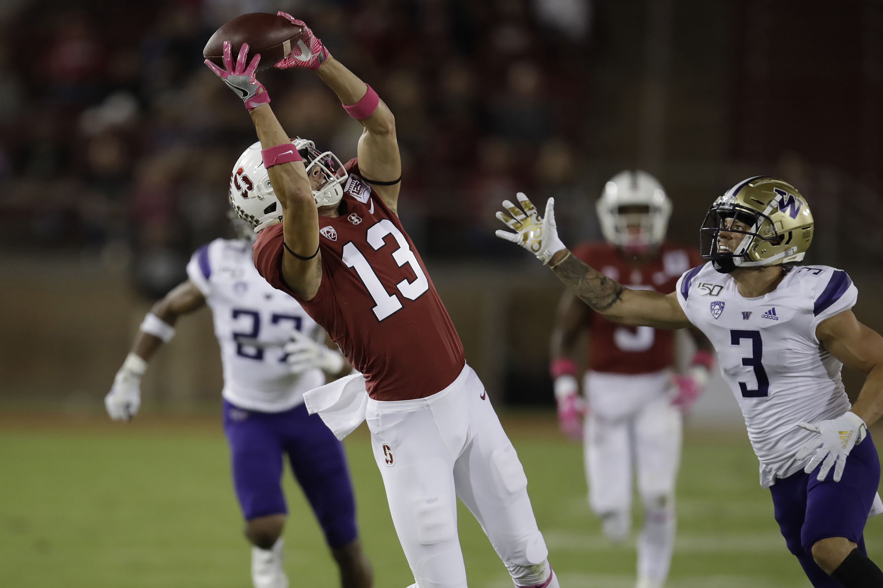 Stanford's Simi Fehoko, left, makes a pass reception past Washington's Elijah Molden (3) in the first half of an NCAA college football game Saturday, Oct. 5, 2019, in Stanford, Calif.