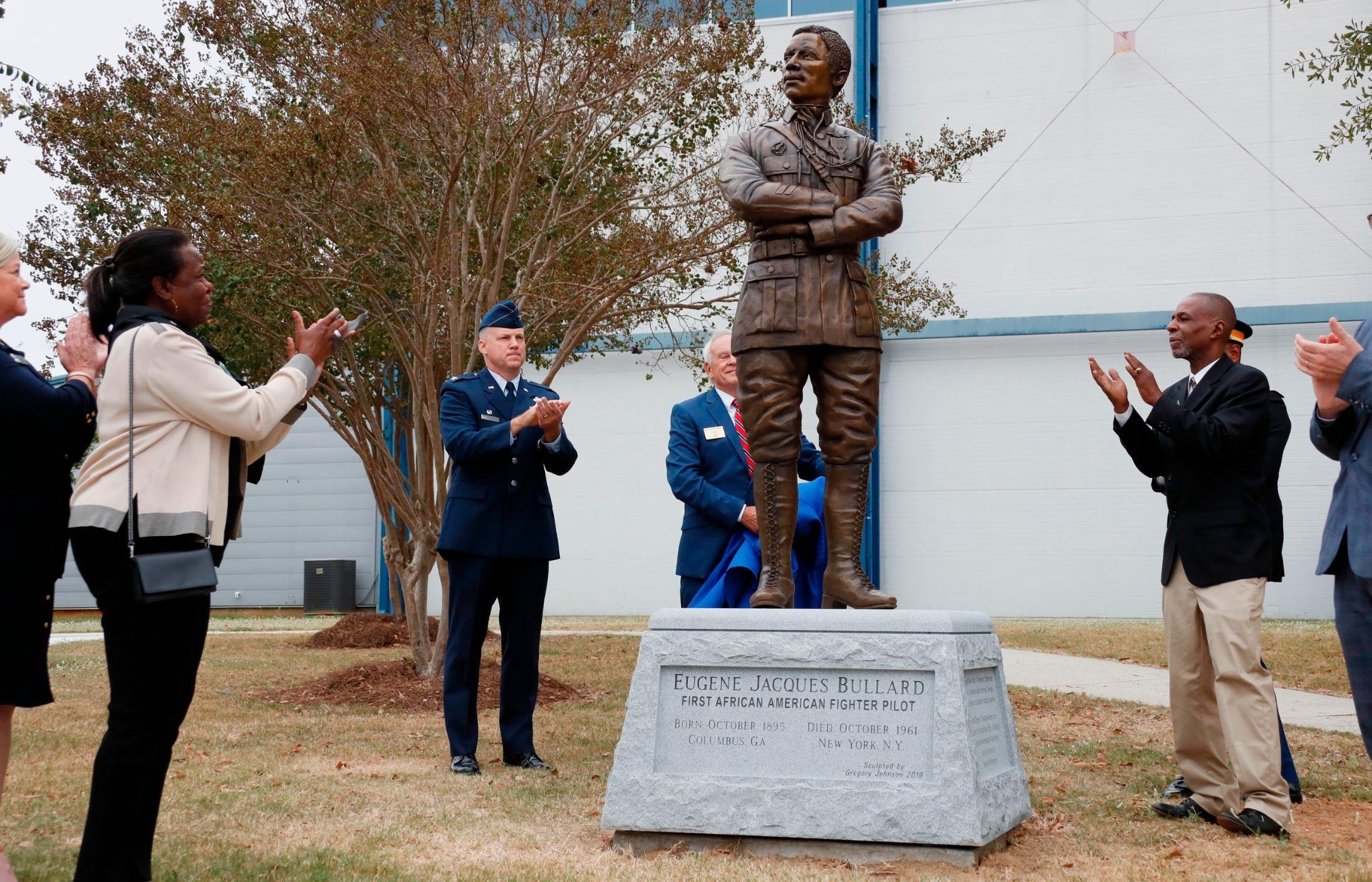 Harriett Bullard White, far left, and William Bullard, far right, join in applause after the statue of Eugene Bullard was unveiled Wednesday at the Museum of Aviation near Robins Air Force Base in Georgia.
(Photo: Bob Andres/AP via CNN)