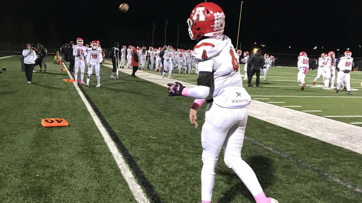 American Fork quarterback Maddux Madsen warms up on the sidelines during the Cavemen's 26-21 win over Lone Peak, Thursday, Oct. 10, 2019 in Highland, Utah.