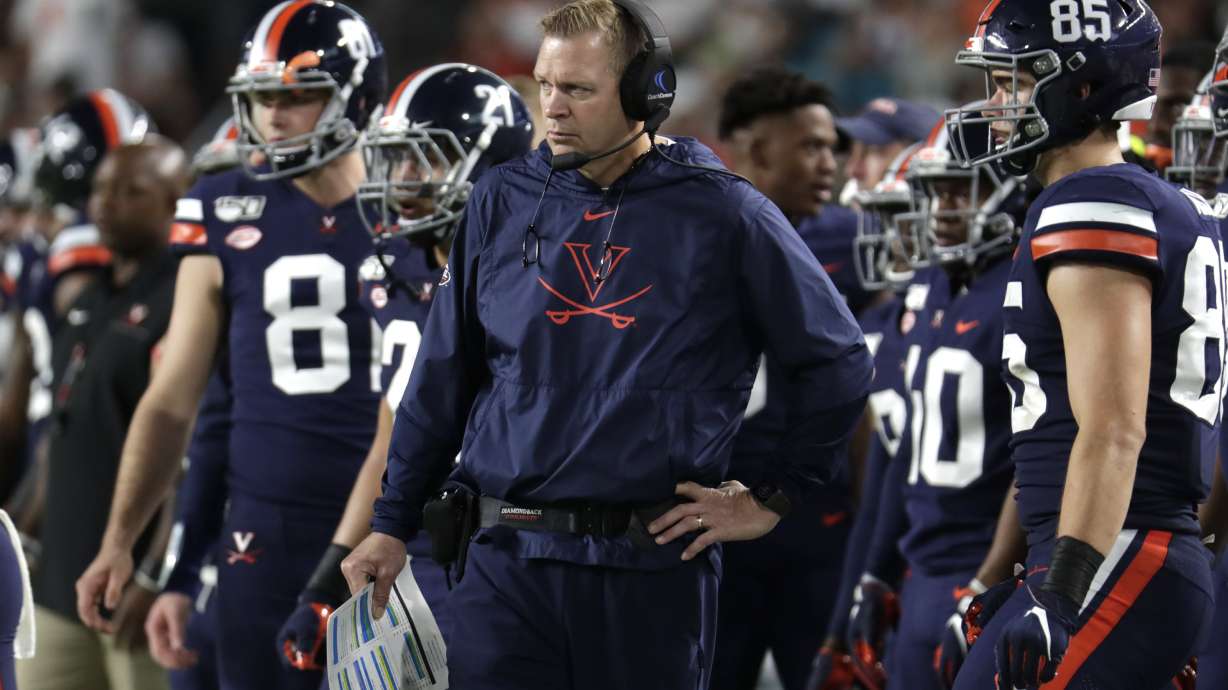 Virginia head coach Bronco Mendenhall watches the first half of an NCAA college football game against Miami, Friday, Oct. 11, 2019, in Miami Gardens, Fla.