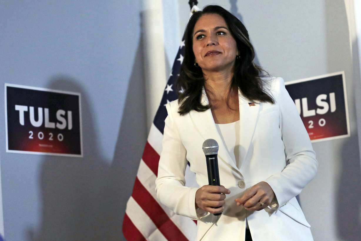 FILE - In this Oct. 1, 2019, file photo, Democratic presidential candidate U.S. Rep. Tulsi Gabbard, D-Hawaii, listens to a question during a campaign stop in Londonderry, N.H. While Gabbard is campaigning for her party's presidential nomination, she faces a strong primary challenge back home for her congressional seat from Democratic state Sen. Kai Kahele. (AP Photo/Charles Krupa, File)