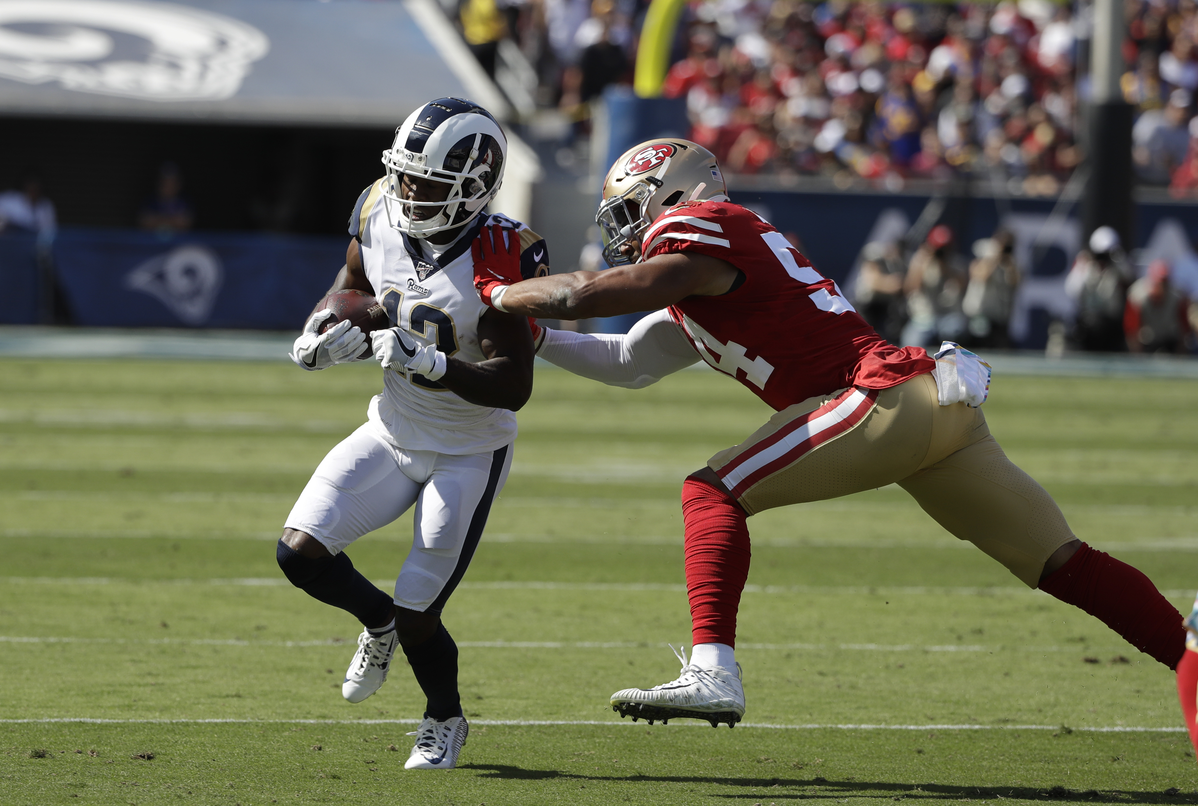 Los Angeles Rams wide receiver Brandin Cooks (12) runs next to San Francisco 49ers middle linebacker Fred Warner during the first half of an NFL football game Sunday, Oct. 13, 2019, in Los Angeles. (Photo: Alex Gallardo, AP)