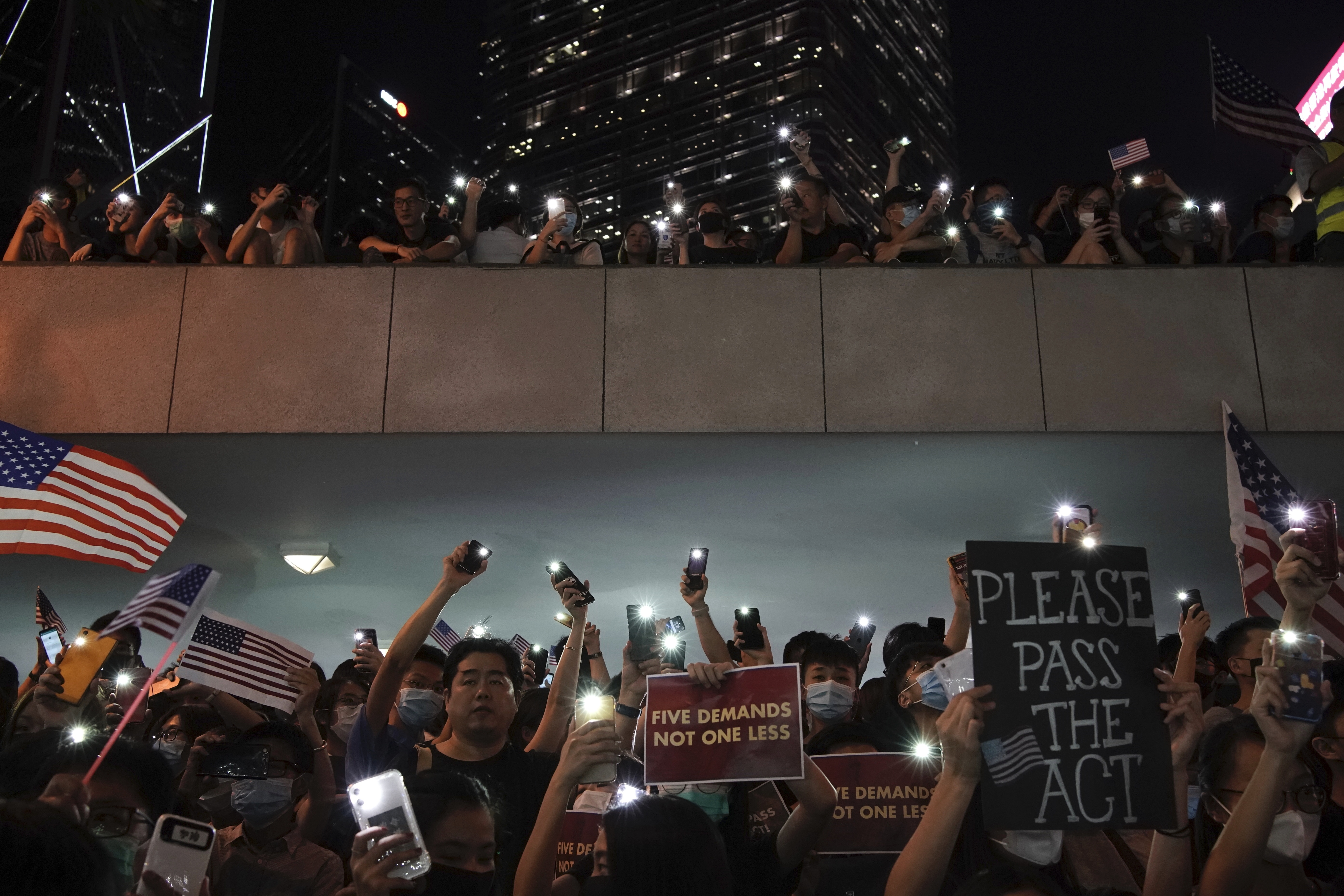 Protestors light their torches during a peaceful rally in central Hong Kong's business district, Monday, Oct. 14, 2019. The protests that started in June over a now-shelved extradition bill have since snowballed into an anti-China campaign amid anger over what many view as Beijing's interference in Hong Kong's autonomy that was granted when the former British colony returned to Chinese rule in 1997. (Photo: Felipe Dana, AP Photo.)