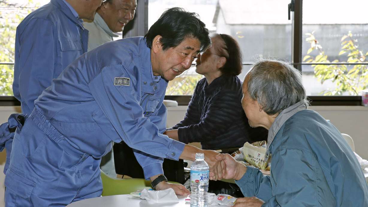 Japan PM visits storm-hit areas, royal parade may be delayed
