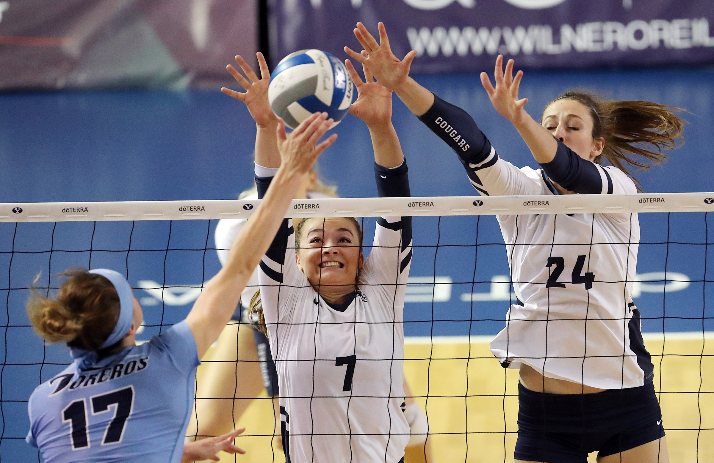 Whitney Bower, center, and Kennedy Eschenberg of BYU try to block a spike by Thana Fayad of San Diego during an NCAA volleyball match in Provo on Friday, Oct. 18, 2019. (Photo: Ravell Call, KSL)