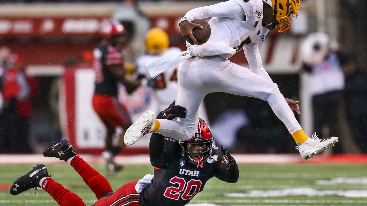 Utah Utes linebacker Devin Lloyd (20) trips up Arizona State Sun Devils quarterback Jayden Daniels (5) and prevents him from going out of bounds near the end of the first half of an NCAA football game at Rice-Eccles Stadium in Salt Lake City on Saturday, Oct. 19, 2019.