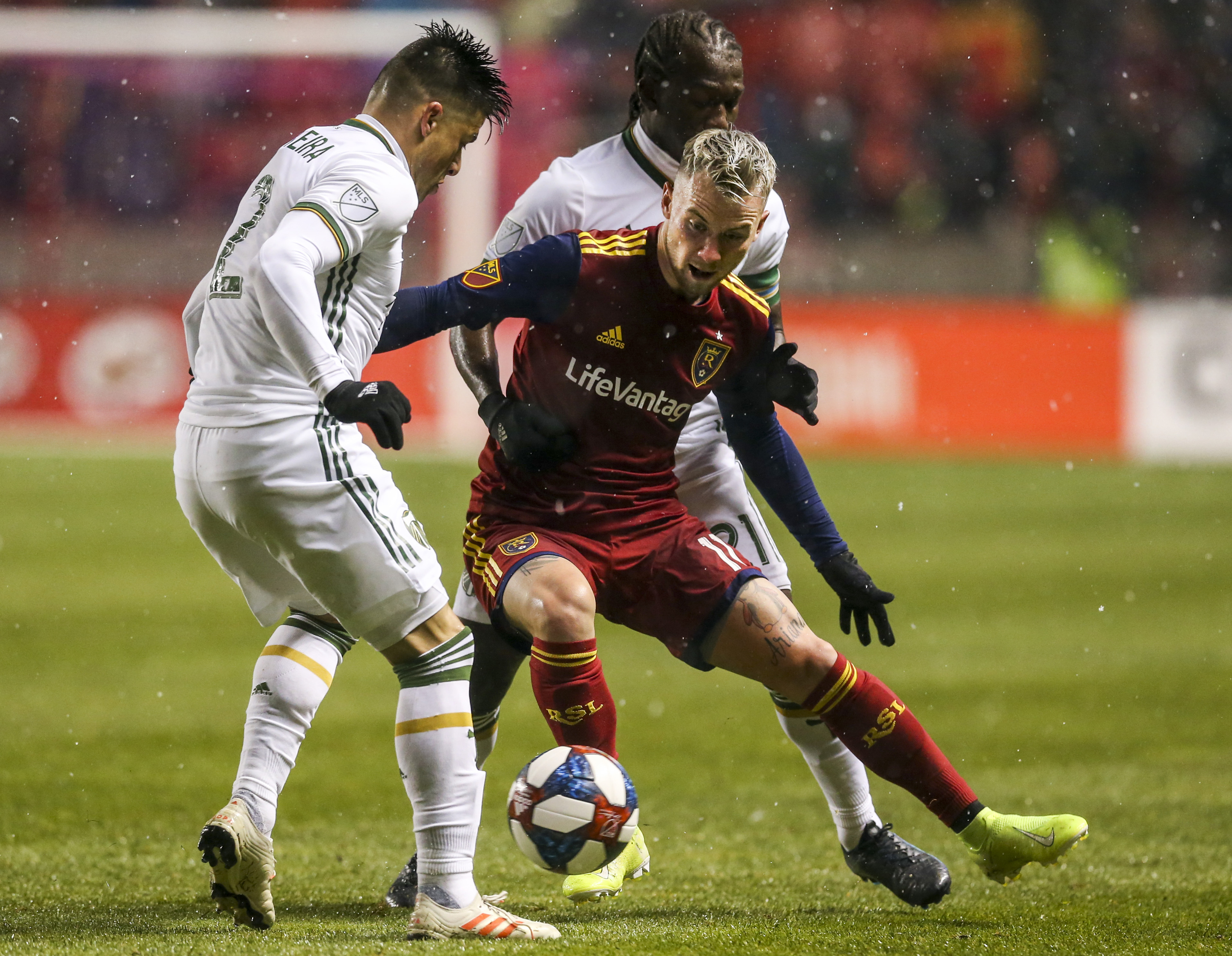 Real Salt Lake midfielder Albert Rusnak (11) works to maintain possession while defended by Portland Timbers defender Jorge Moreira (2) and midfielder Diego Chara (21) during the second half of a Major League Soccer playoff game at Rio Tinto Stadium in Sandy on Saturday, Oct. 19, 2019. (Photo: Colter Peterson, KSL)