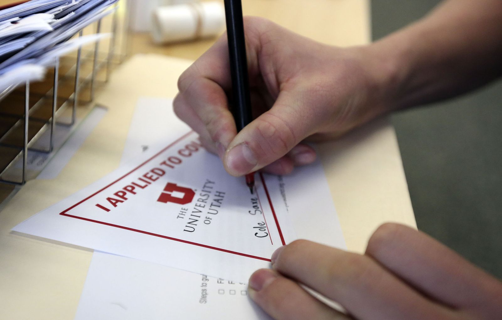 Cole Saxey signs a paper that shows he applied to the University of Utah during Utah College Application Week at Hillcrest High School in Midvale on Tuesday, Oct. 22, 2019. (Photo: Kristin Murphy, KSL)