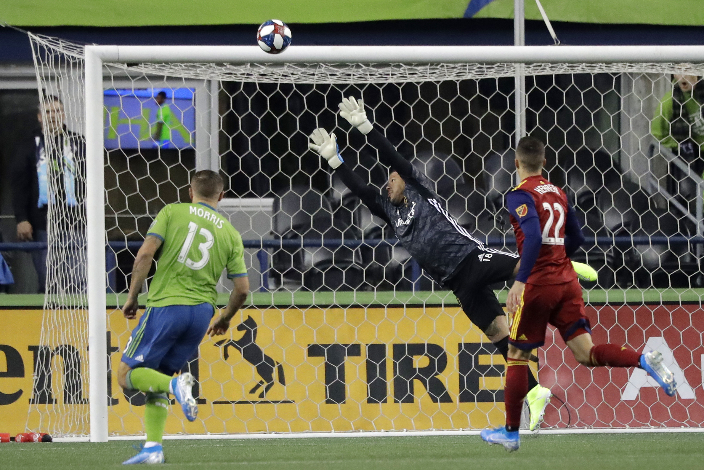 Real Salt Lake goalkeeper Nick Rimando, center, leaps as a shot goes wide and Seattle Sounders forward Jordan Morris, left, and Real Salt Lake defender Aaron Herrera, right, watch during the first half of an MLS Western Conference semifinal playoff soccer match Wednesday, Oct. 23, 2019, in Seattle. (Photo: Ted S. Warren, AP)