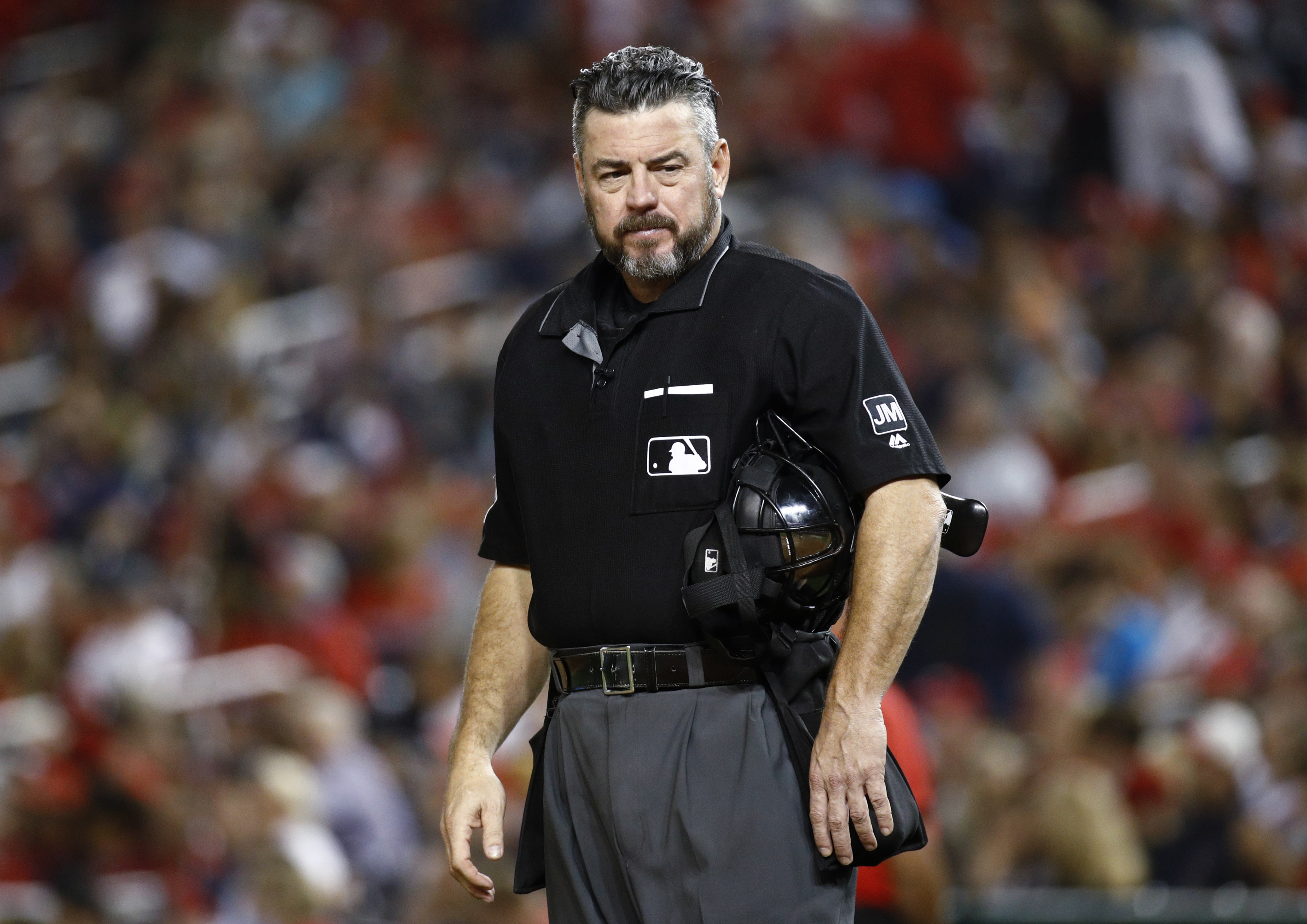 Ump apologizes for tweet referencing gun and Trump critics