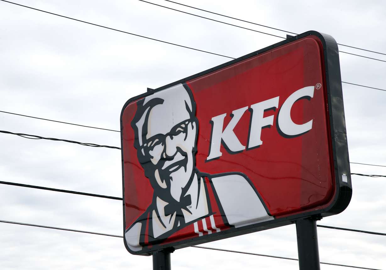 FILE - In this Friday, Jan. 31, 2014, file photo, a KFC sign hangs in Saugus, Mass. KFC says it wants to take a bigger bite out of the chicken sandwich market. The chain says it is switching from “freezer-to-fryer” filets in favor of filets breaded in stores, similar to how rivals Chick-fil-A and Popeye’s already prepare their chicken. The company says chicken sandwiches account for 40 percent of the fast-food industry’s chicken category, and that it is not a big enough player in that business. (Photo: Elise Amendola, AP Photo, File)